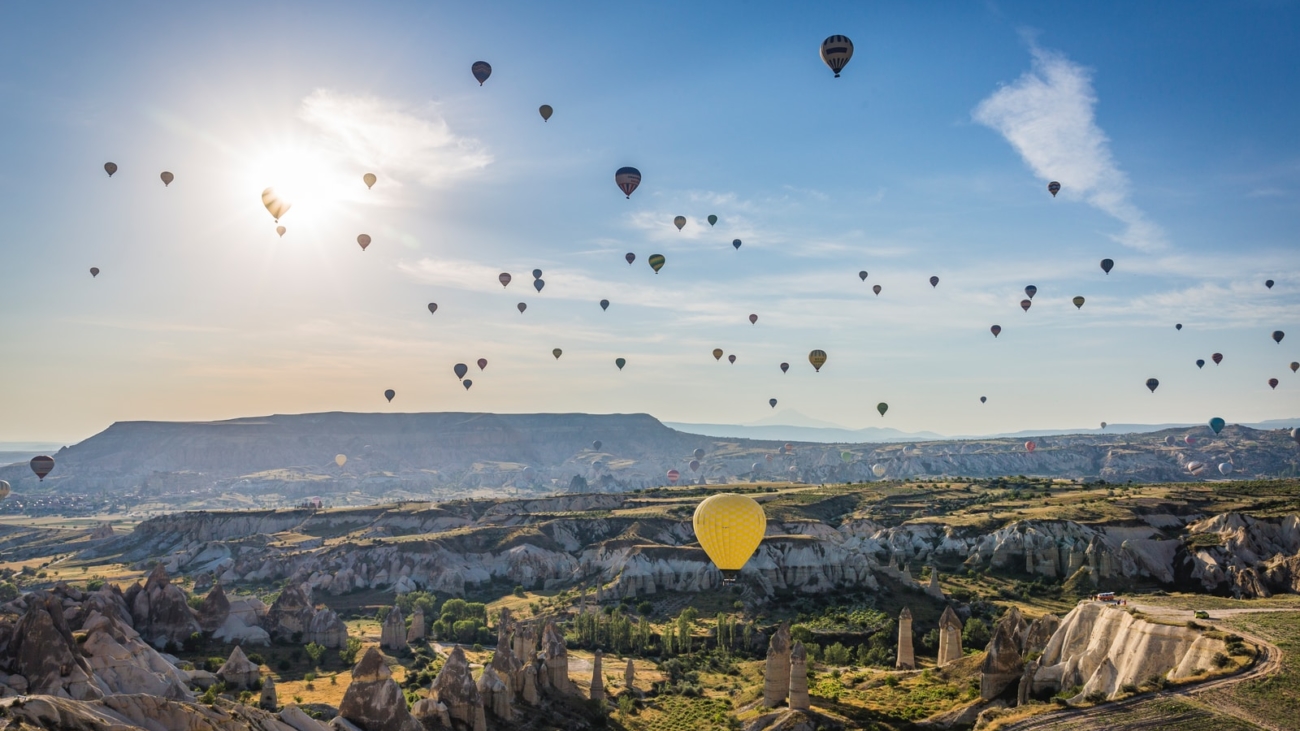 hot air balloons flying over city during daytime