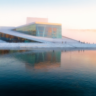 gray building near body of water under white sky